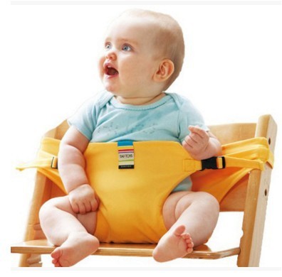 Baby sitting in a yellow high chair with a white background