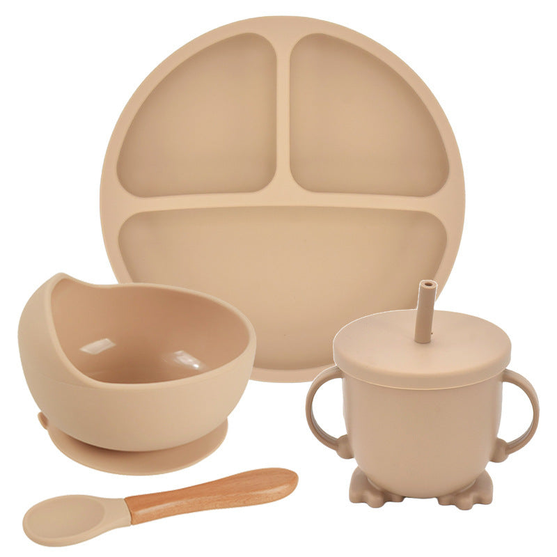 Beige children's dining set with plate, bowl, cup, and spoon on a white background