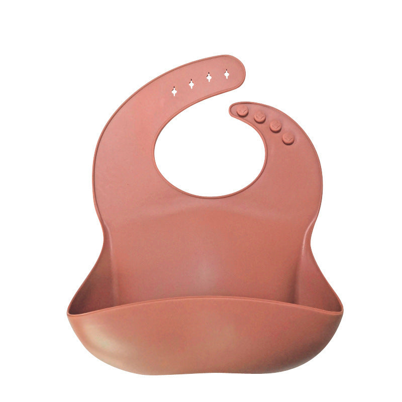 Pink silicone bib on a white background