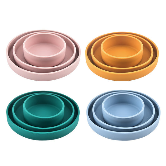 Set of four nested bowls in pink, yellow, blue, and green on a white background