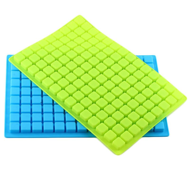 Green and blue silicone ice cube trays on a white background