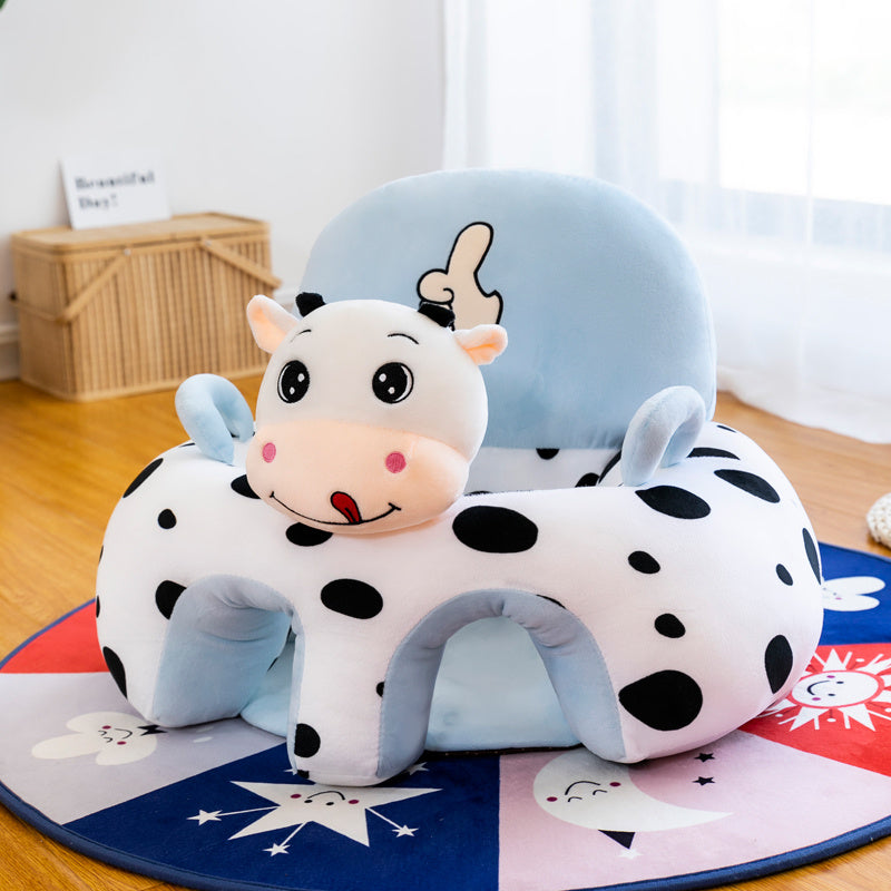 Children's seat with cow design on a colorful mat
