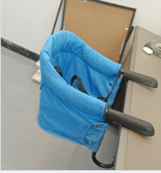 Blue baby bouncer with black handles on a light gray surface.