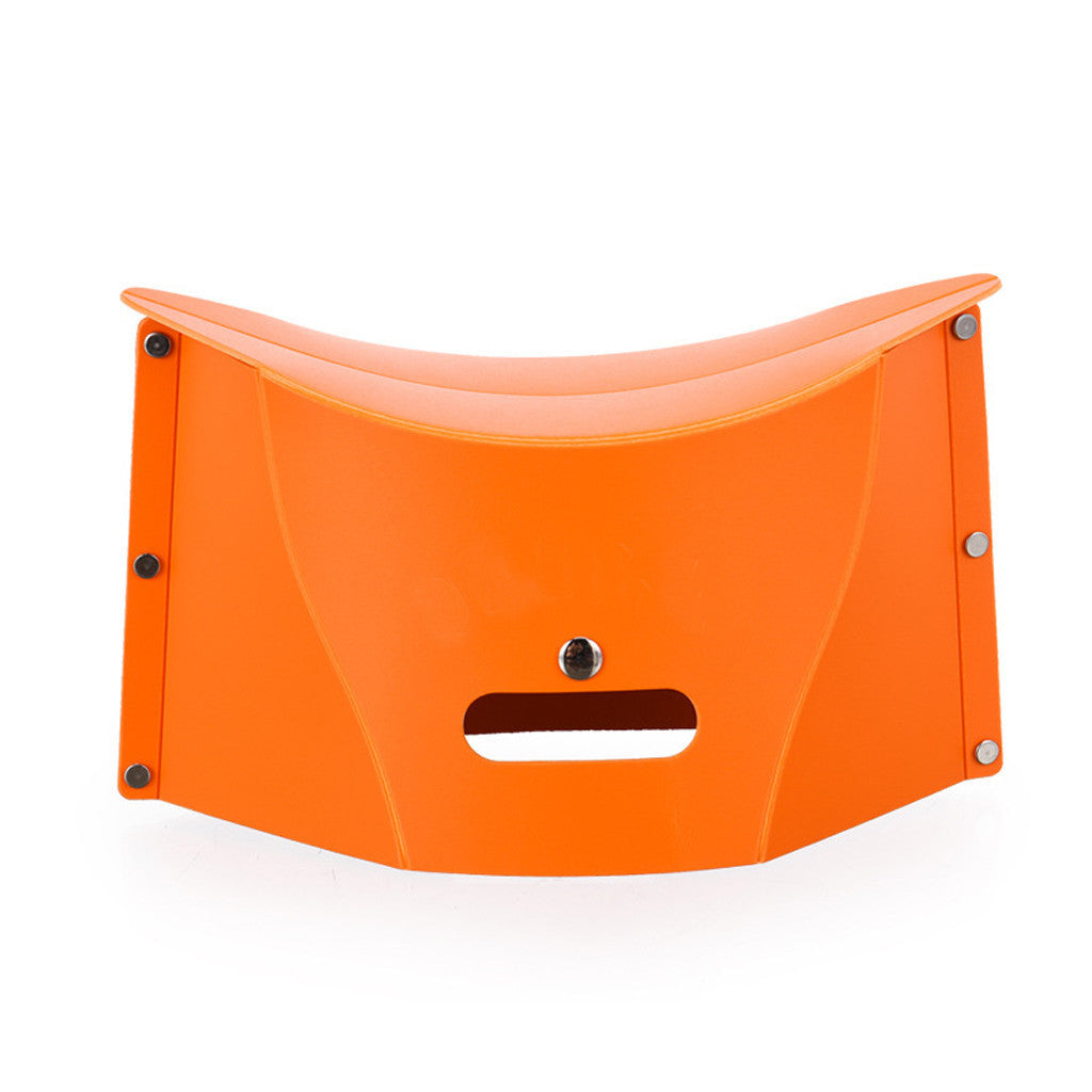 Orange folding stool on a white background