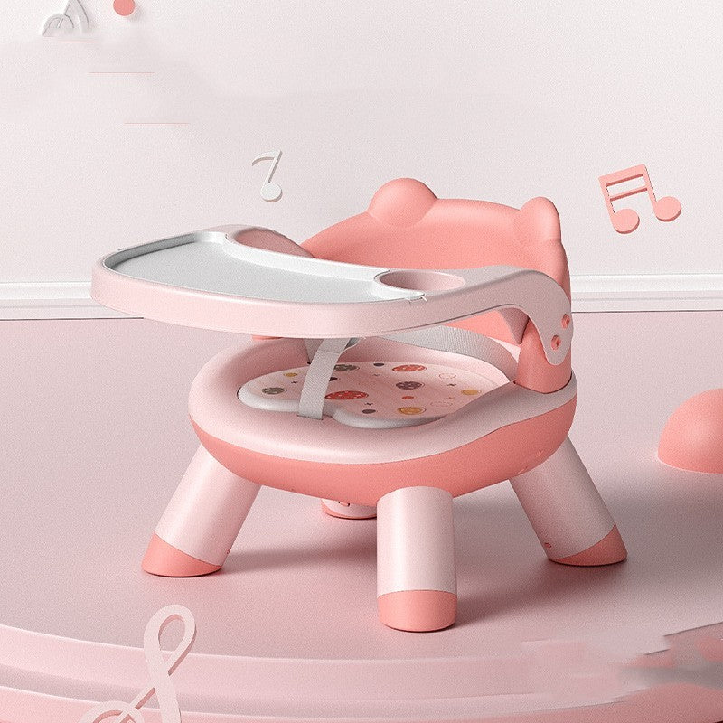 Pink and white children's chair with a tray on a light pink background