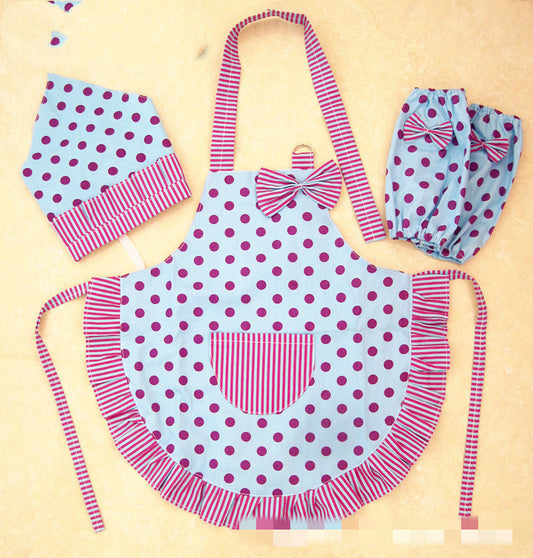 Children's apron with polka dot design and matching hat and bloomers on a beige background