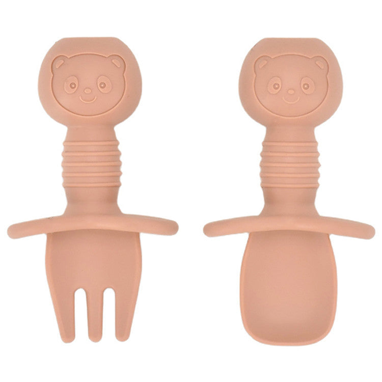 Two pink bear-shaped baby utensils on a white background