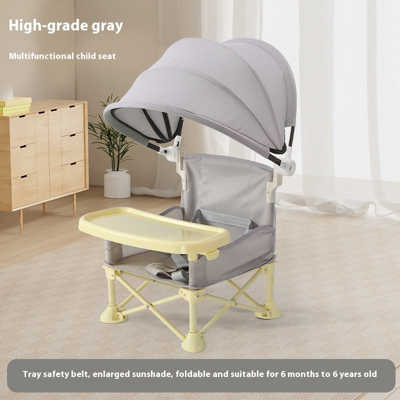 Multifunctional child seat with tray and canopy in a room setting