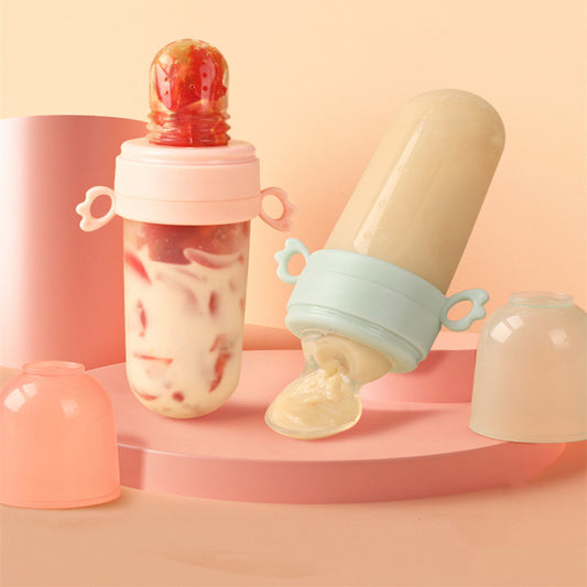 Two baby food feeders on a pink platform with a soft pink background