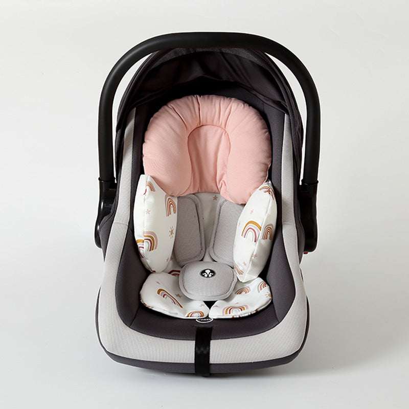 Baby car seat with pink and white cushion on a light gray background