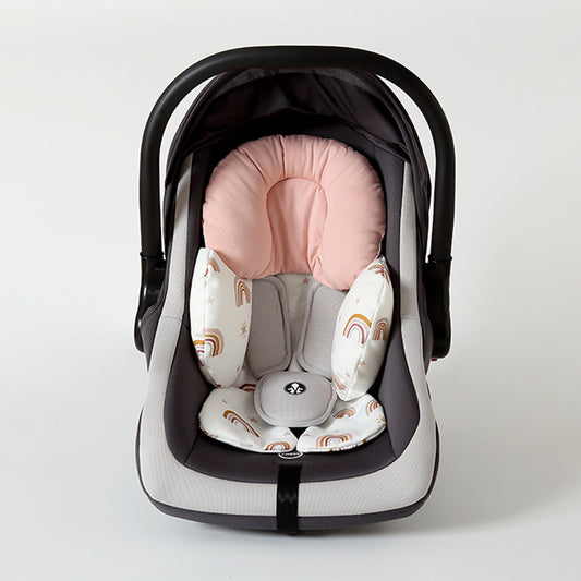 Baby car seat with pink and white cushion on a light gray background