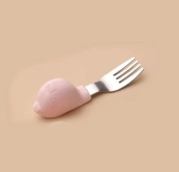 Pink spoon and fork set on a beige background