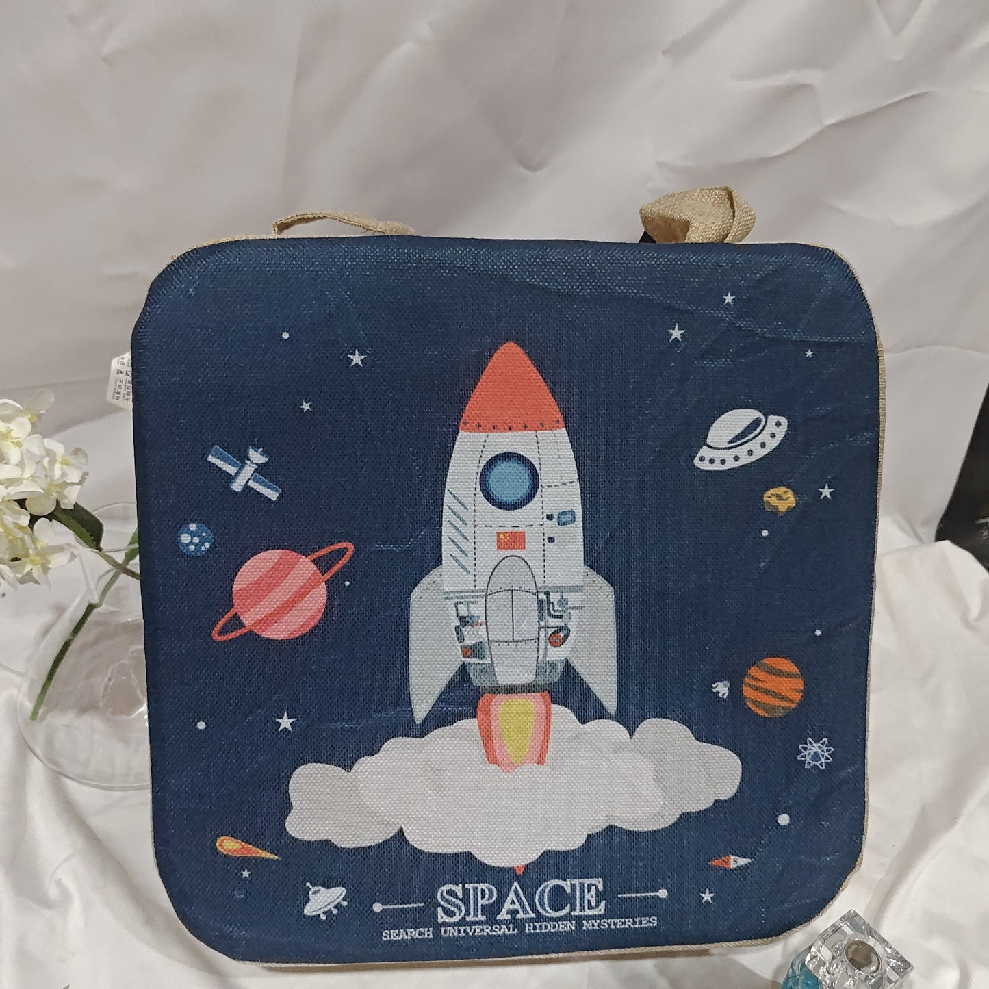 Navy blue pouch with space-themed design featuring a rocket and planets on a white fabric background.