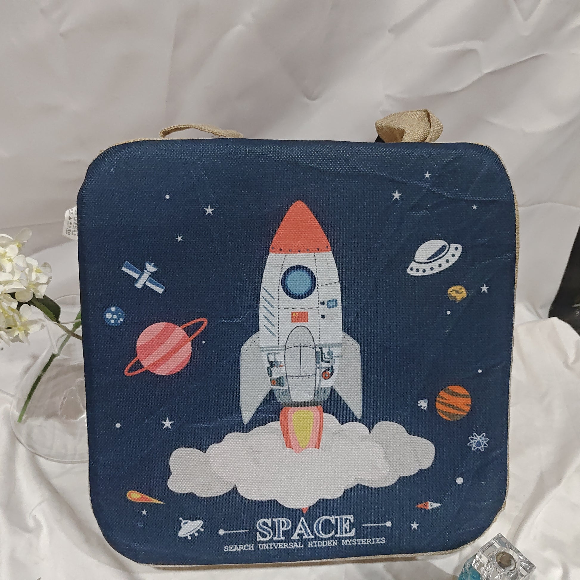 Navy blue pouch with space-themed design featuring a rocket and planets on a white fabric background.