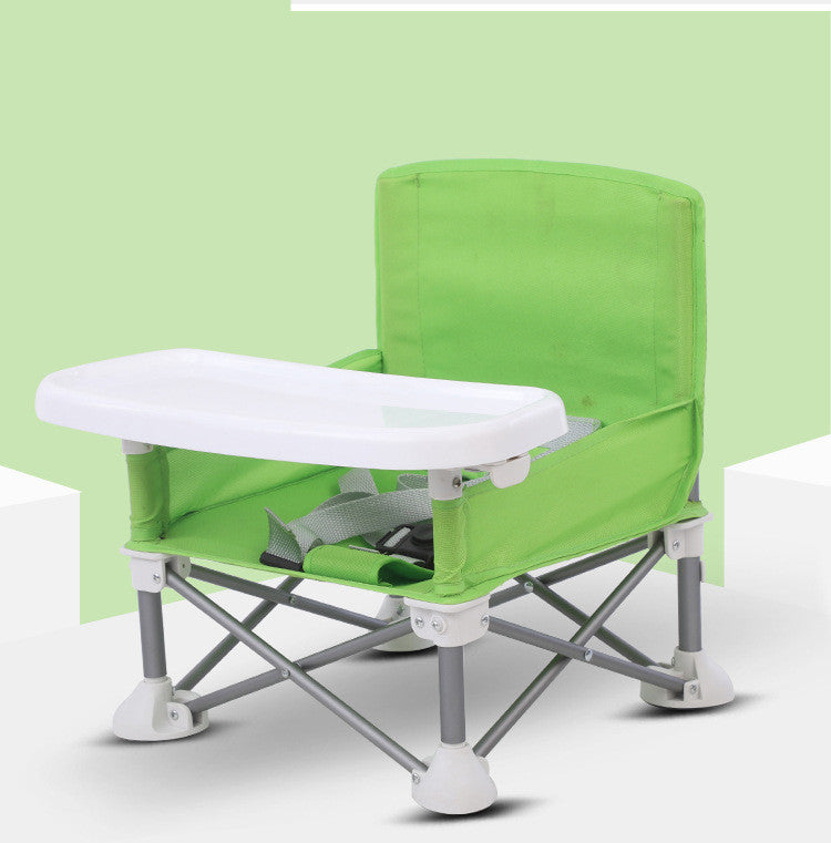 Green and white folding chair with tray on a light green background