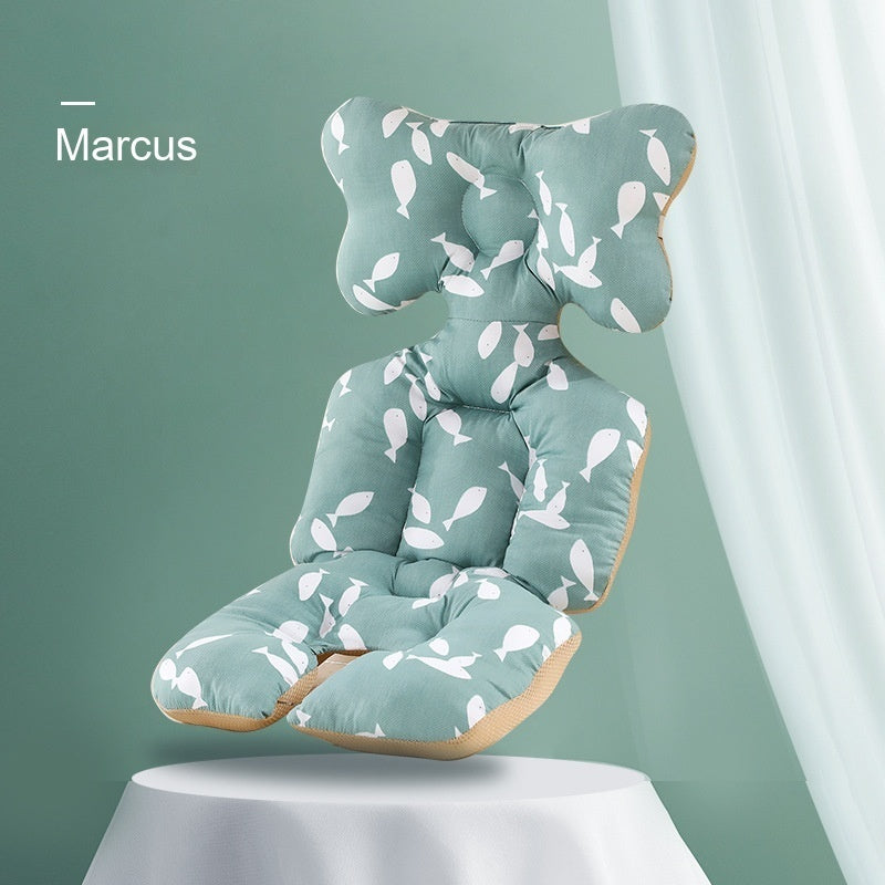 Green cushion with leaf pattern on a white pedestal against a green background, branded 'Marcus'.