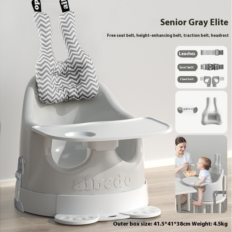 Gray baby high chair with additional accessories on a white background