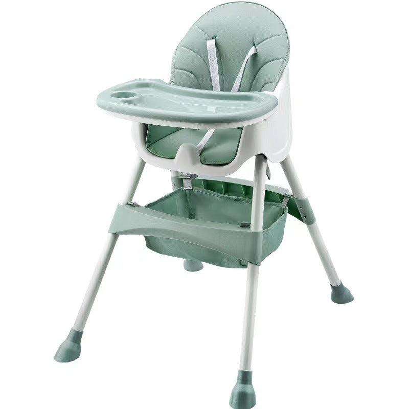 Green and white baby high chair on a white background