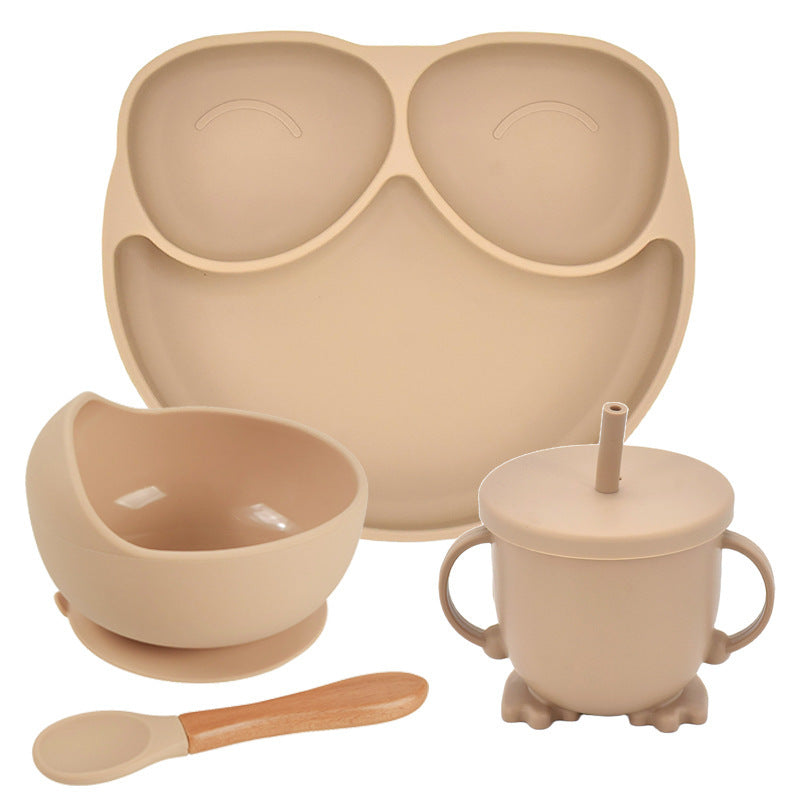 Beige baby吃饭 set with bowl, cup, spoon, and placemat on a white background