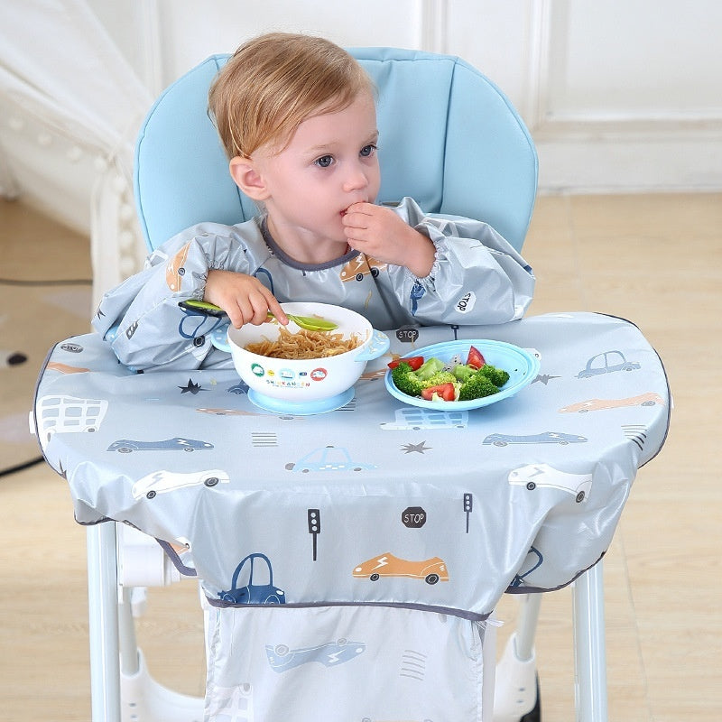 Child sitting in a high chair with a blue tray eating a meal.