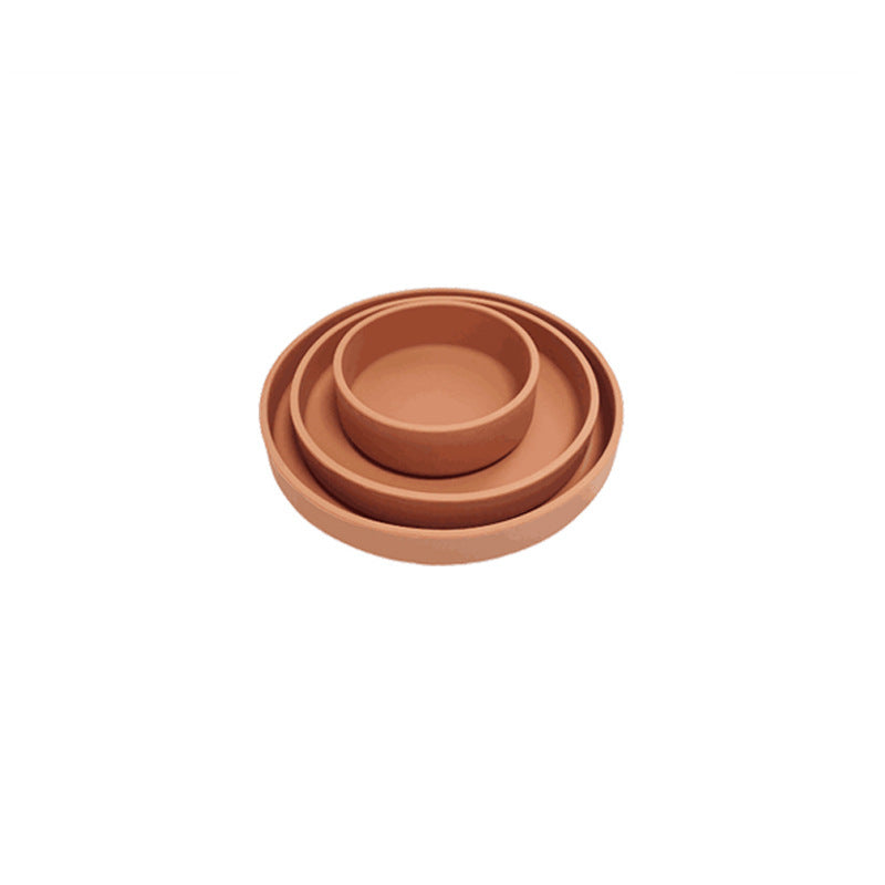 Set of three terracotta pots on a white background