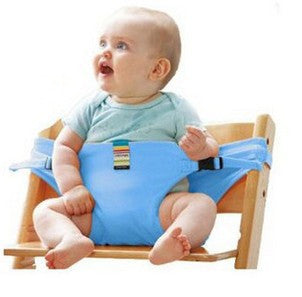 Baby sitting in a blue seat with a wooden frame, wearing a light blue shirt.