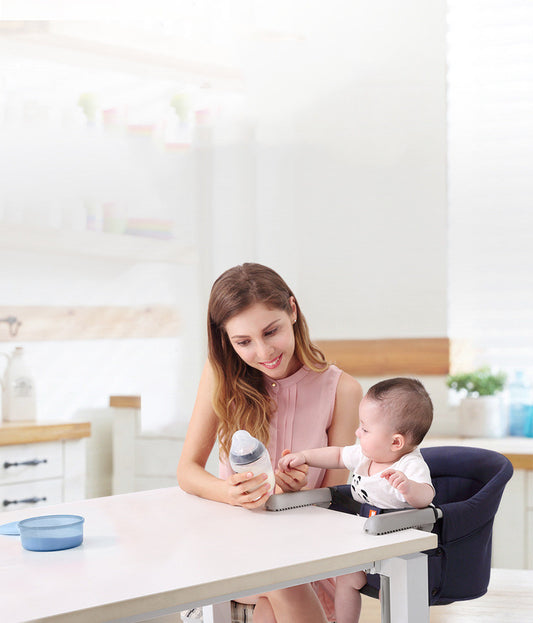 Woman with a baby using a high chair in a kitchen setting