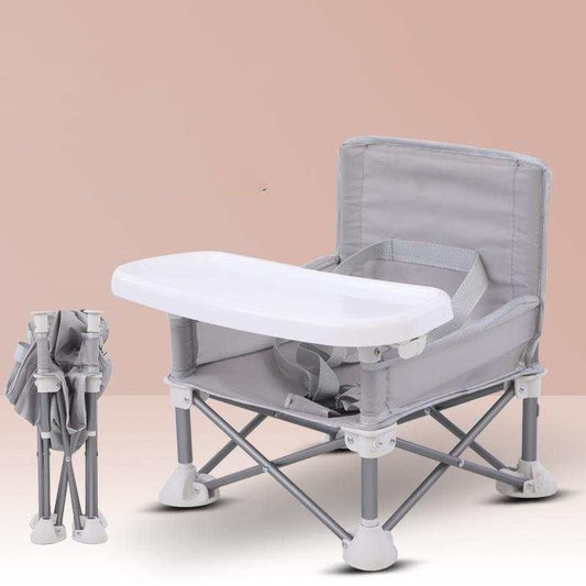 Foldable baby dining chair with a white tray on a beige background