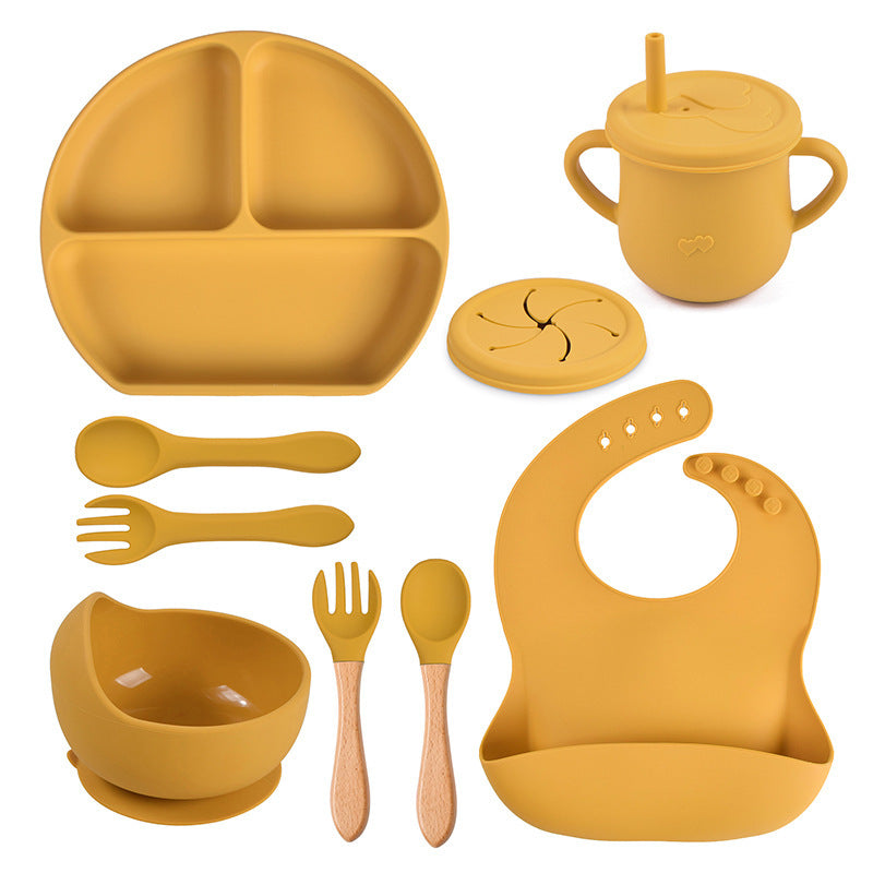 Yellow silicone baby吃饭 set including plate, cup, bowl, utensils, and bib on a white background