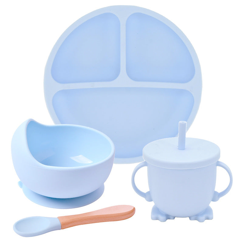 Set of blue silicone dining utensils including a plate, bowl, cup, and spoon on a white background.