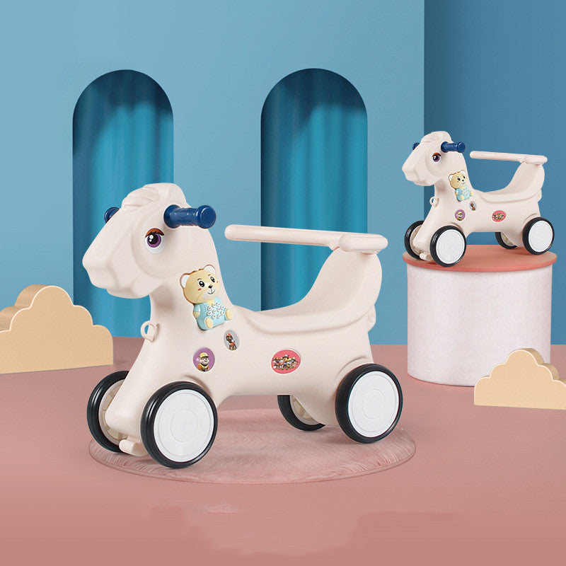 Children's toy horse with wheels on a pink platform against a blue background