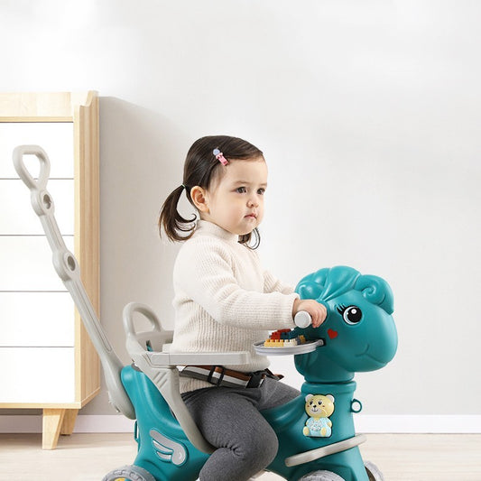 Child sitting on a blue toy horse with a white background