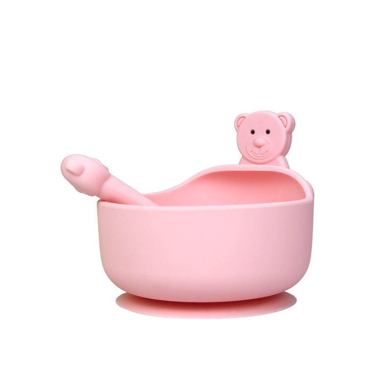 Pink children's bowl and spoon set with a bear-shaped handle on a white background