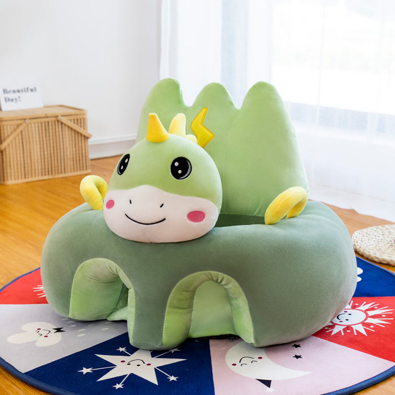 Green dragon-shaped cushion on a colorful rug with a window in the background