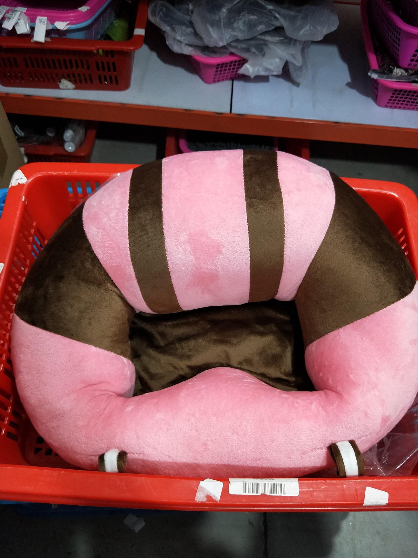Pink and brown striped pet bed in a red shopping cart