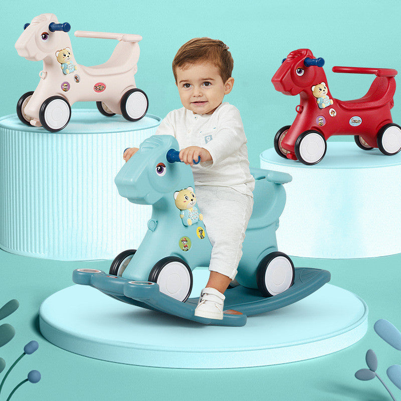 Child playing with a blue toy horse on a teal background