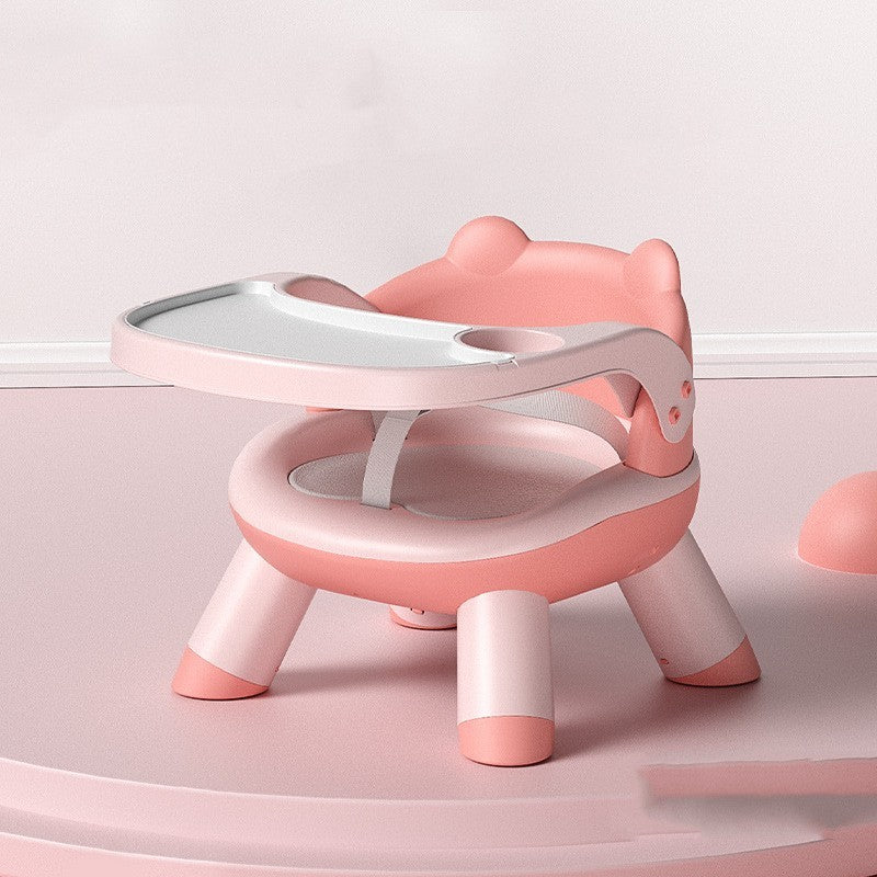 Pink and white children's chair with a small table on a light pink background