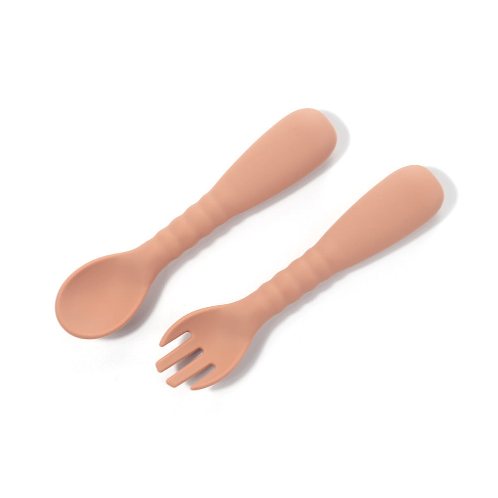 Set of silicone spoon and fork on a white background