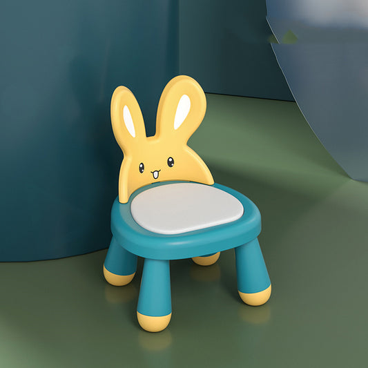 Children's chair with bunny design on a green surface