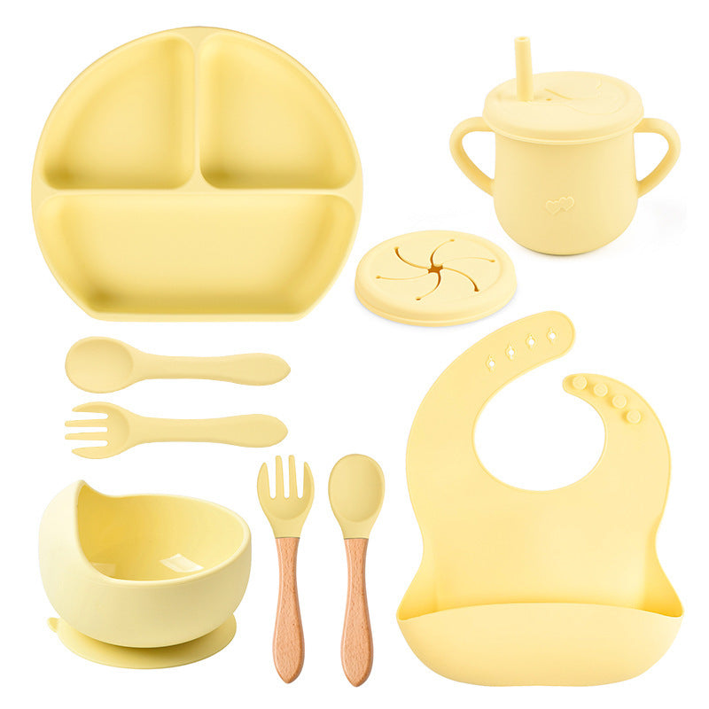 Yellow baby吃饭 set including plate, cup, bowl, utensils, and bib on a white background