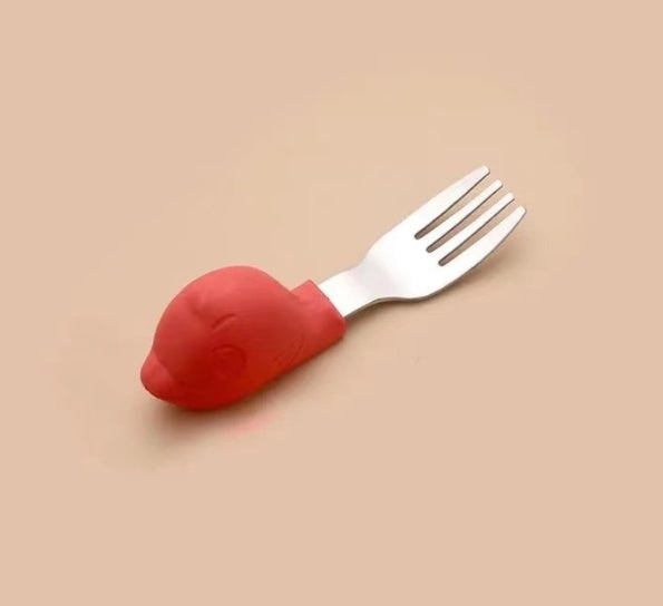 Fork with a red handle on a beige background