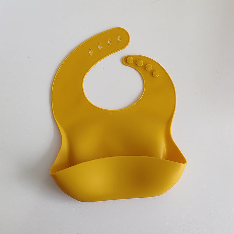Yellow silicone bib on a white background