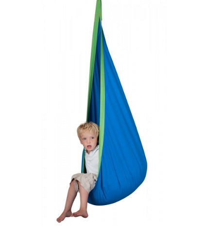 Child sitting in a blue and green hanging chair on a white background