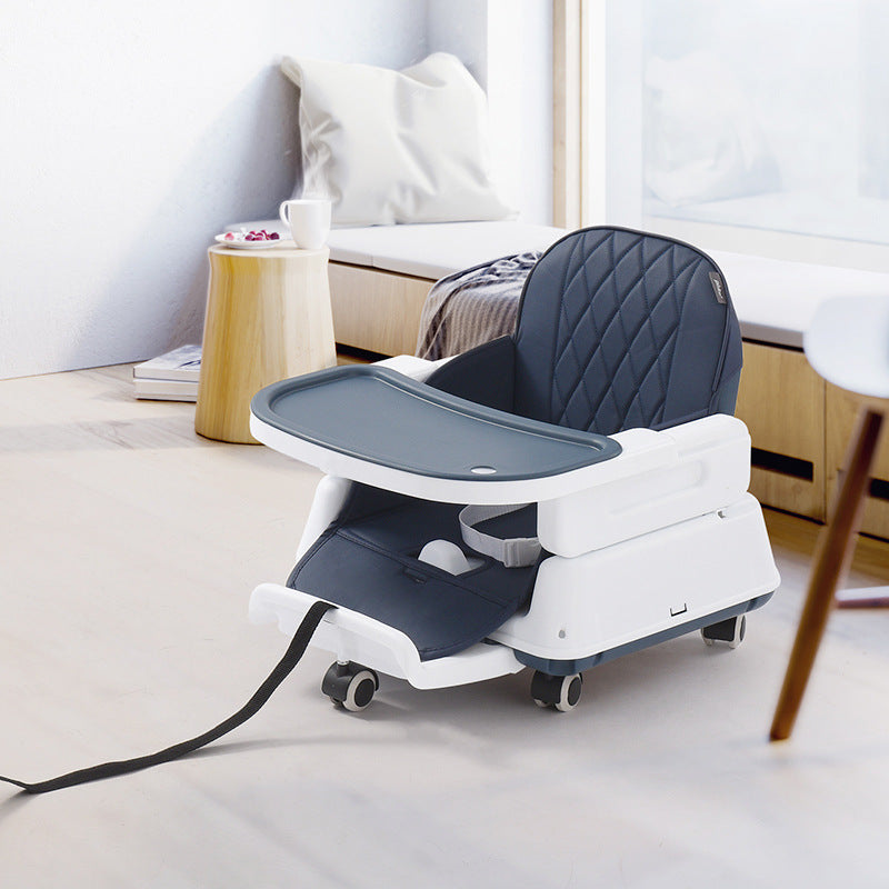 White and gray high chair with power cord on a light-colored floor.