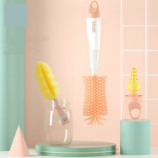 Babystart bottle cleaning brush set with a glass container and yellow sponge on a pastel background
