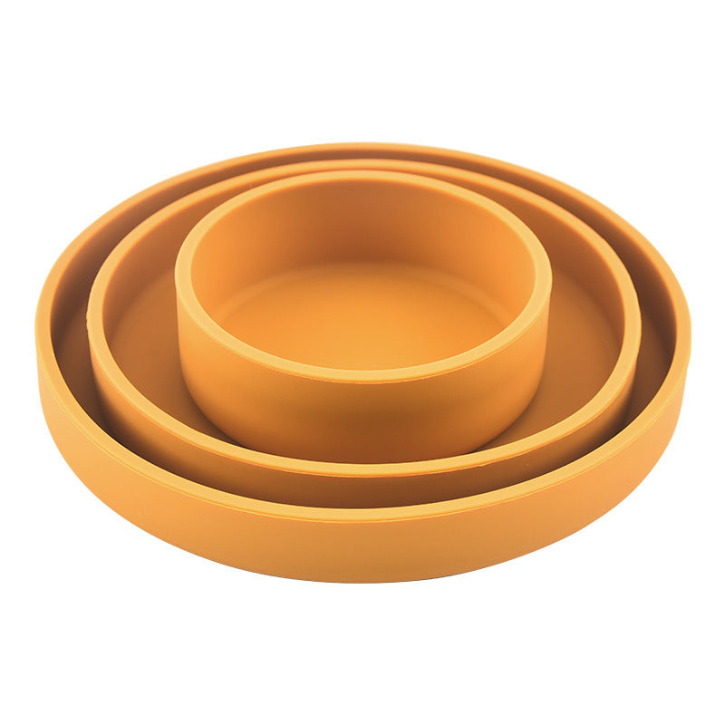 Set of three yellow ceramic bowls of different sizes on a white background