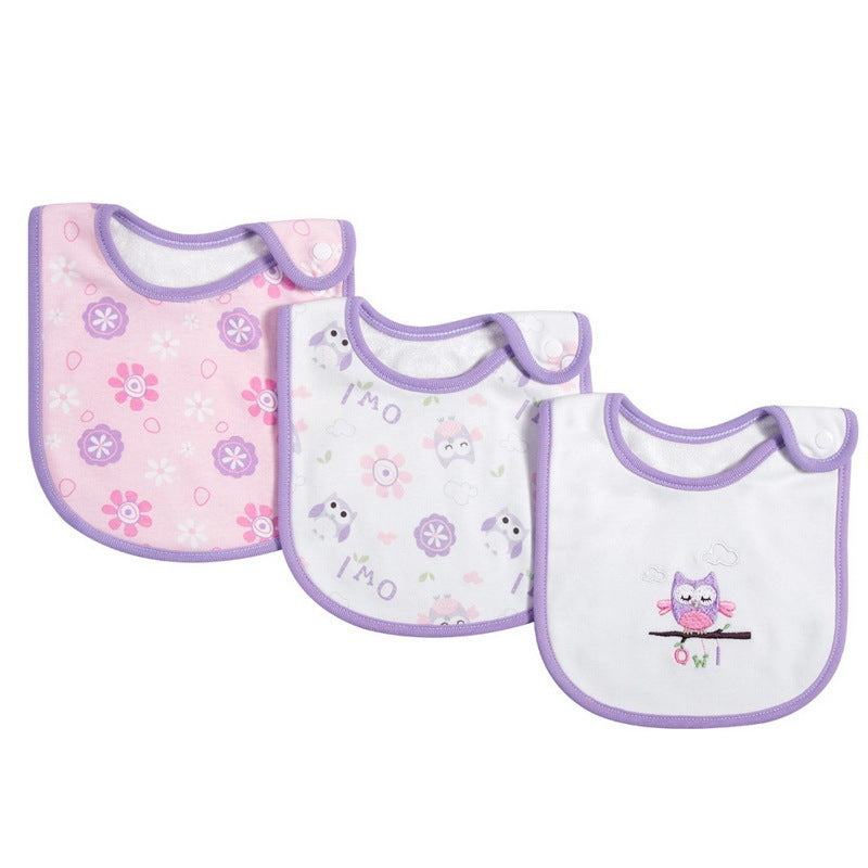 Three baby bibs with owl and floral patterns on a white background