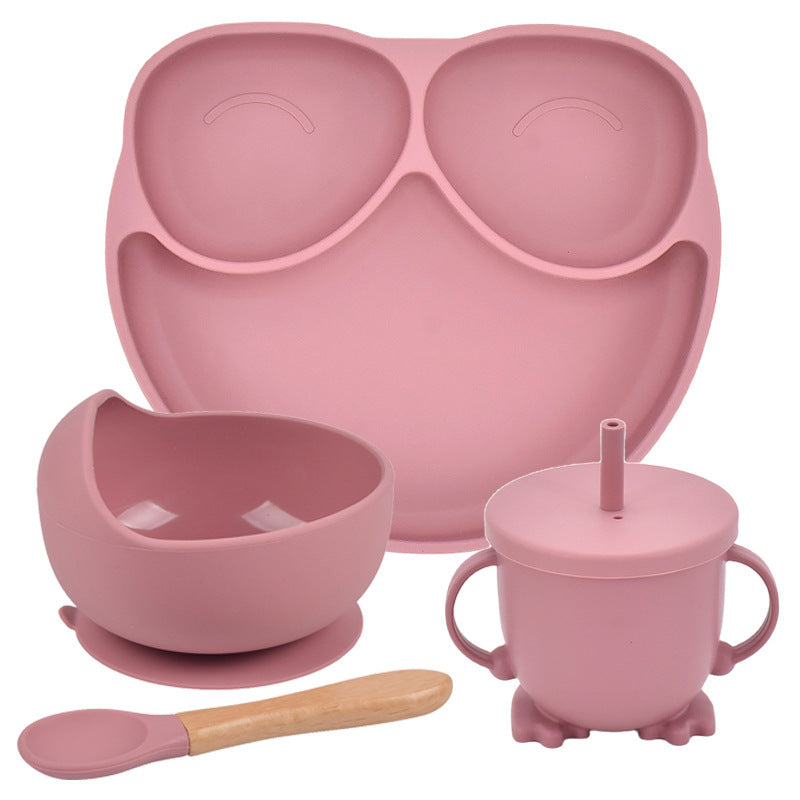 Pink silicone dining set with plate, bowl, cup, and spoon on a white background