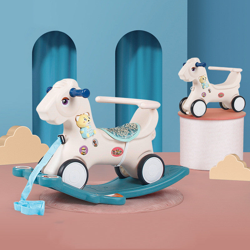 White rocking horse with blue accents on a pink platform against a blue wall.