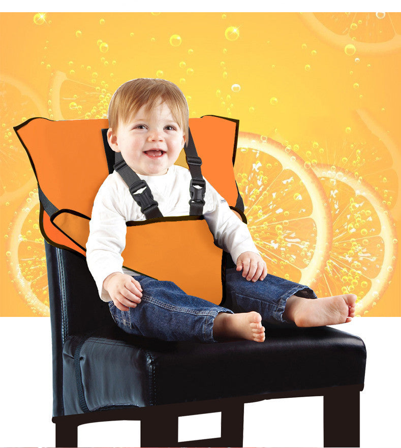 Child in an orange safety seat on a chair with a bright yellow background